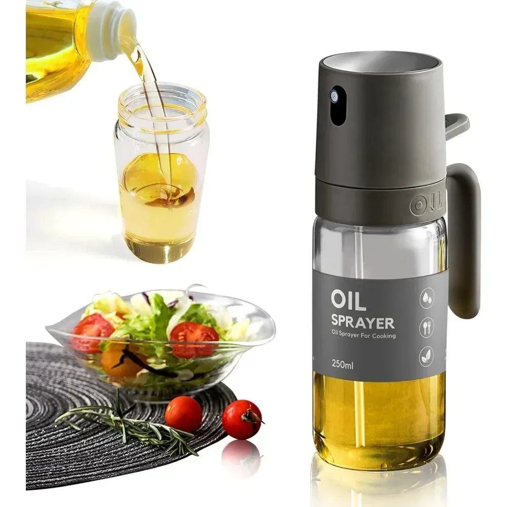 Pulvérisateur d'huile d'olive en verre posé sur un plan de travail de cuisine