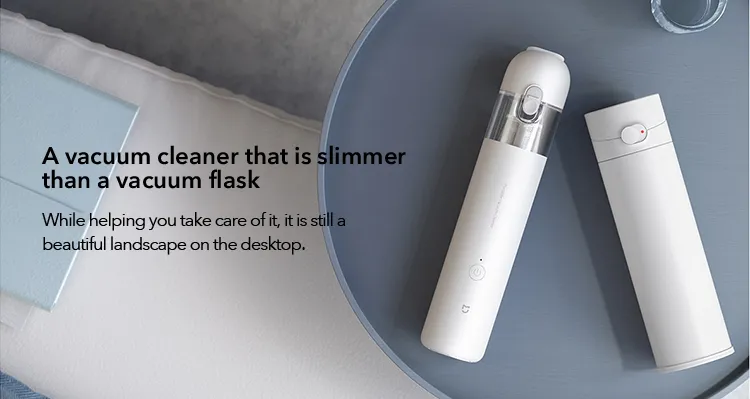 Aspirateur à main Mijia en utilisation sur la banquette d'une voiture